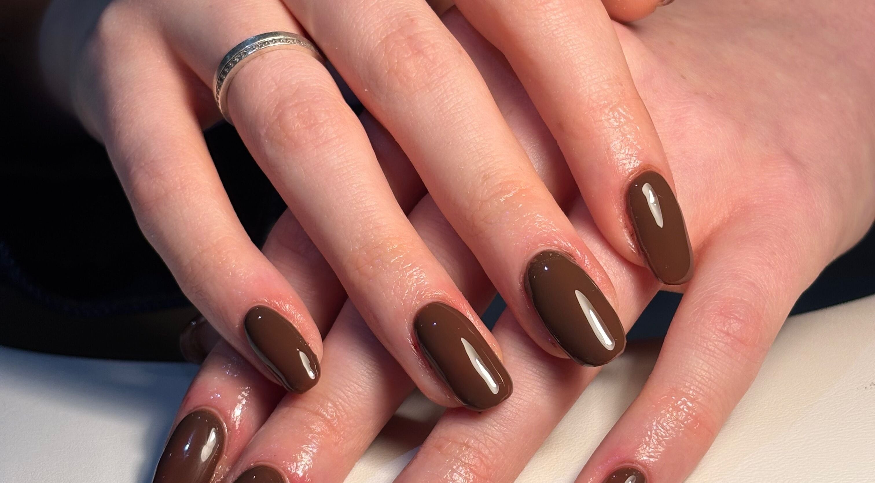 Elegant brown manicure at The Glam Shack, Mawsley, England, GB showcasing glossy nail finish.