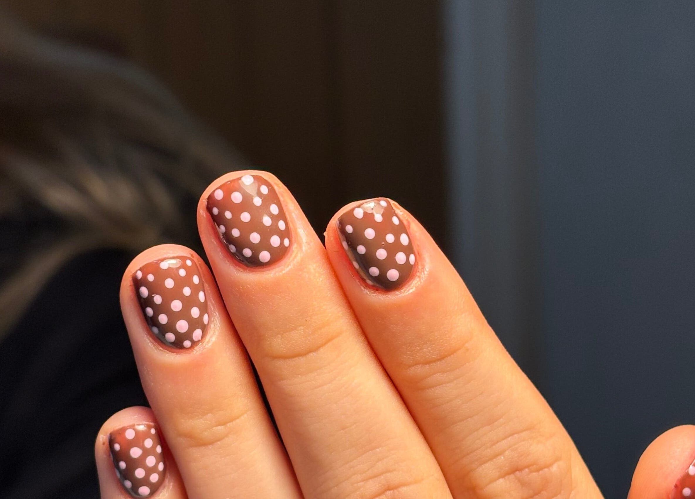 Polka dot nail art at The Glam Shack in Mawsley, England, GB, showcasing chic brown and white design.