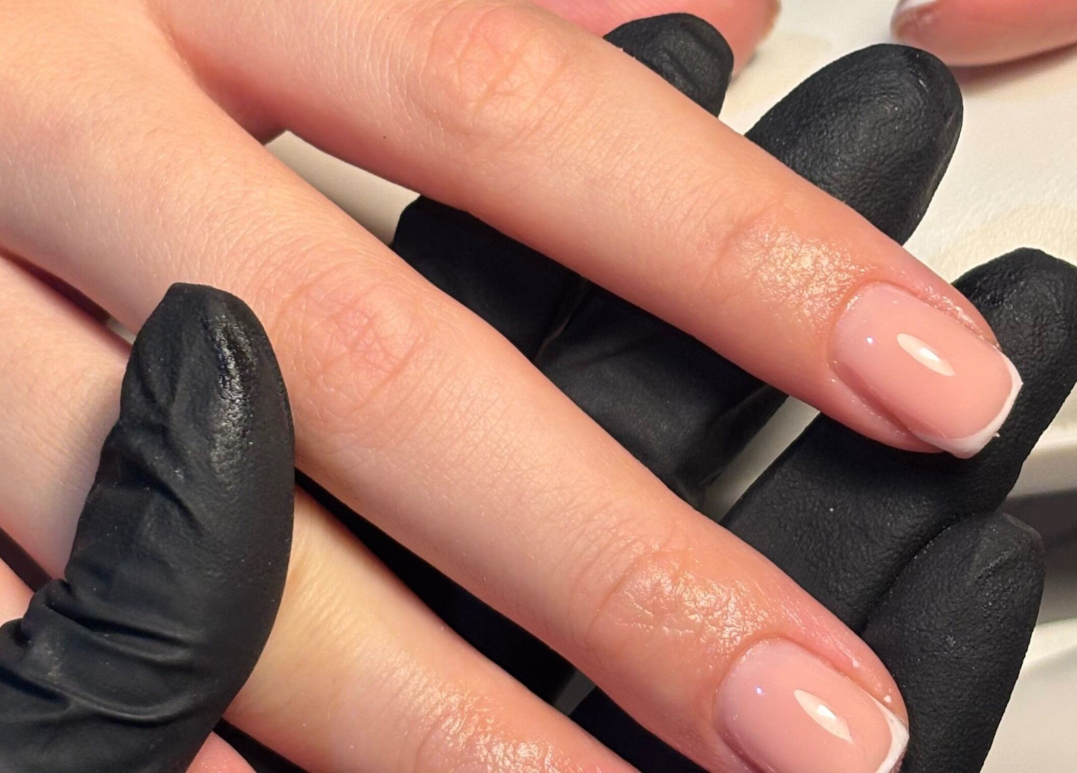 Manicure at The Glam Shack, Mawsley, England, GB. Hand with glossy nails highlighted.