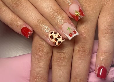 Stylish cherry and animal print nails by Beauty By Hannah in Moorside, England, GB.