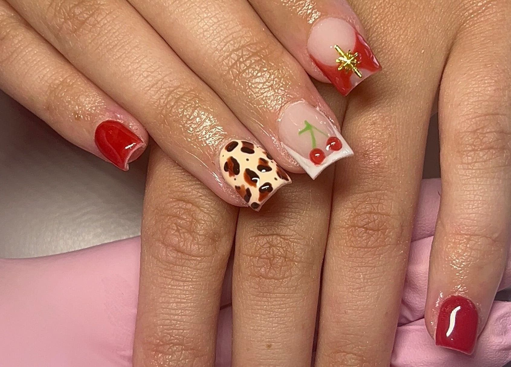 Stylish cherry and animal print nails by Beauty By Hannah in Moorside, England, GB.