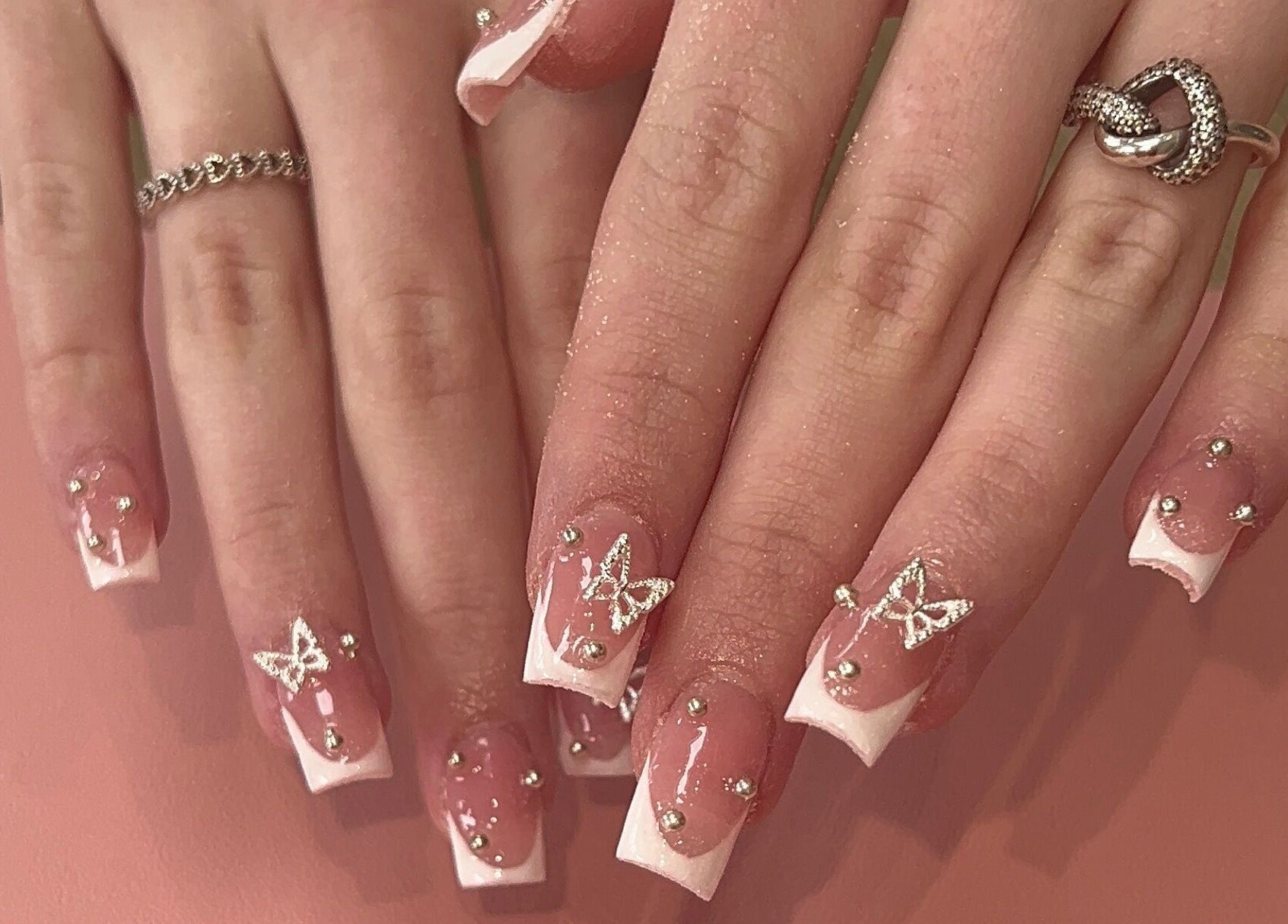 Elegant butterfly nail art at Beauty By Hannah, Moorside, England, GB, featuring intricate designs and embellishments.