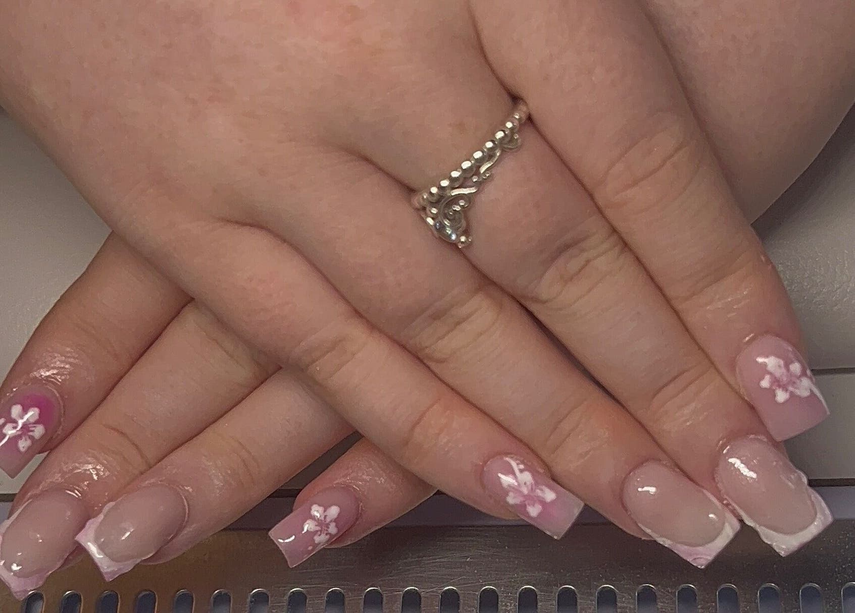 Beautiful floral nail art at Beauty By Hannah in Moorside, England, GB, showcasing delicate pink and white designs.
