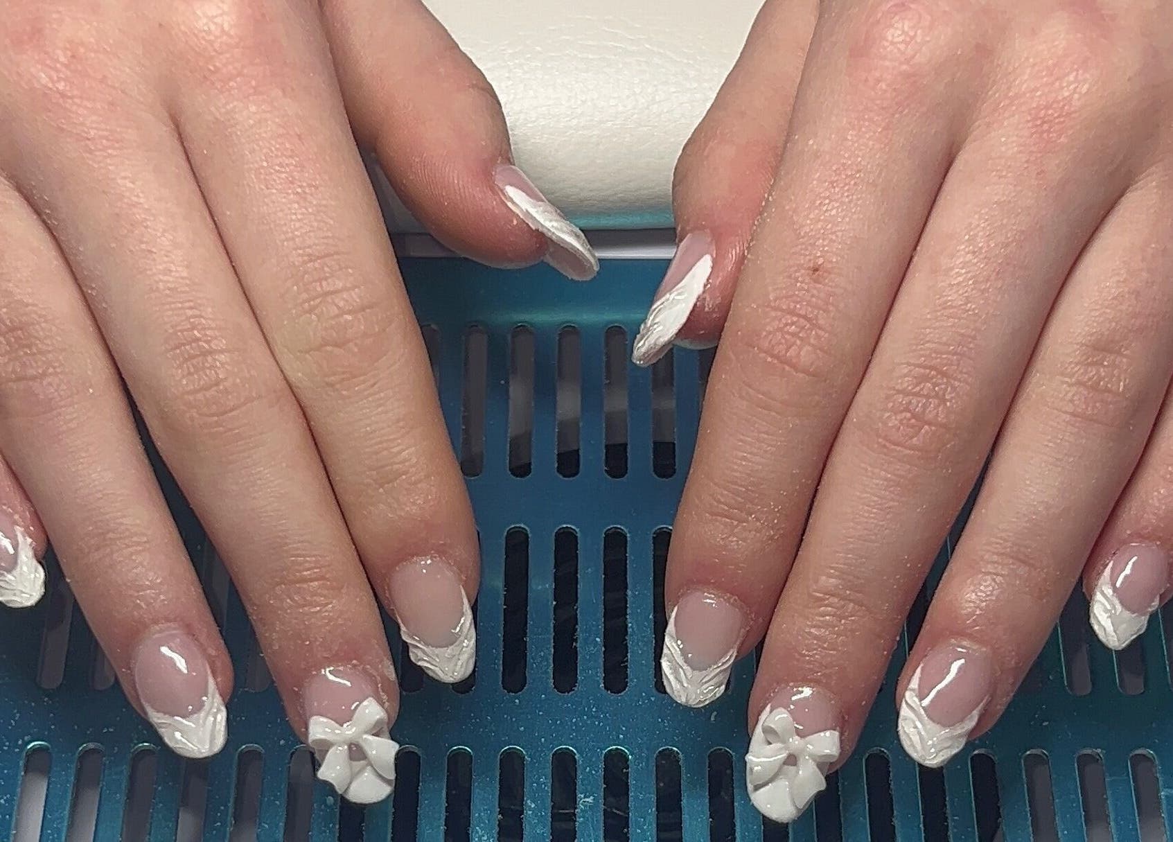 Intricate white floral nail art at Beauty By Hannah, Moorside, England, GB.