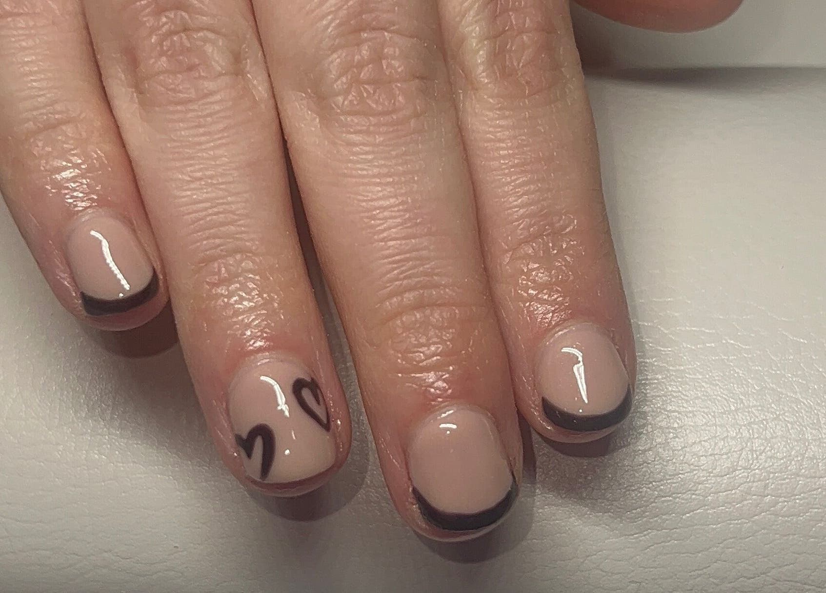 Elegant nail design with black tips and hearts by Beauty By Hannah, Moorside, England, GB.
