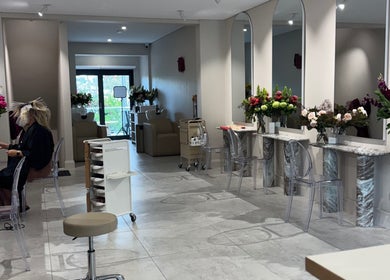 Interior of Giovanna Angela Hair in Birchgrove, NSW, AU, showcasing modern styling stations and floral decor.