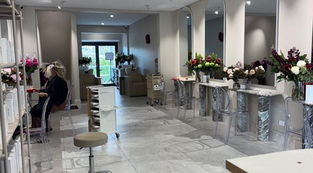 Interior of Giovanna Angela Hair in Birchgrove, NSW, AU, showcasing modern styling stations and floral decor.