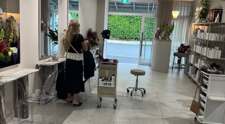 Modern interior of Giovanna Angela Hair salon in Birchgrove, New South Wales, AU. Elegant styling station and products displayed.
