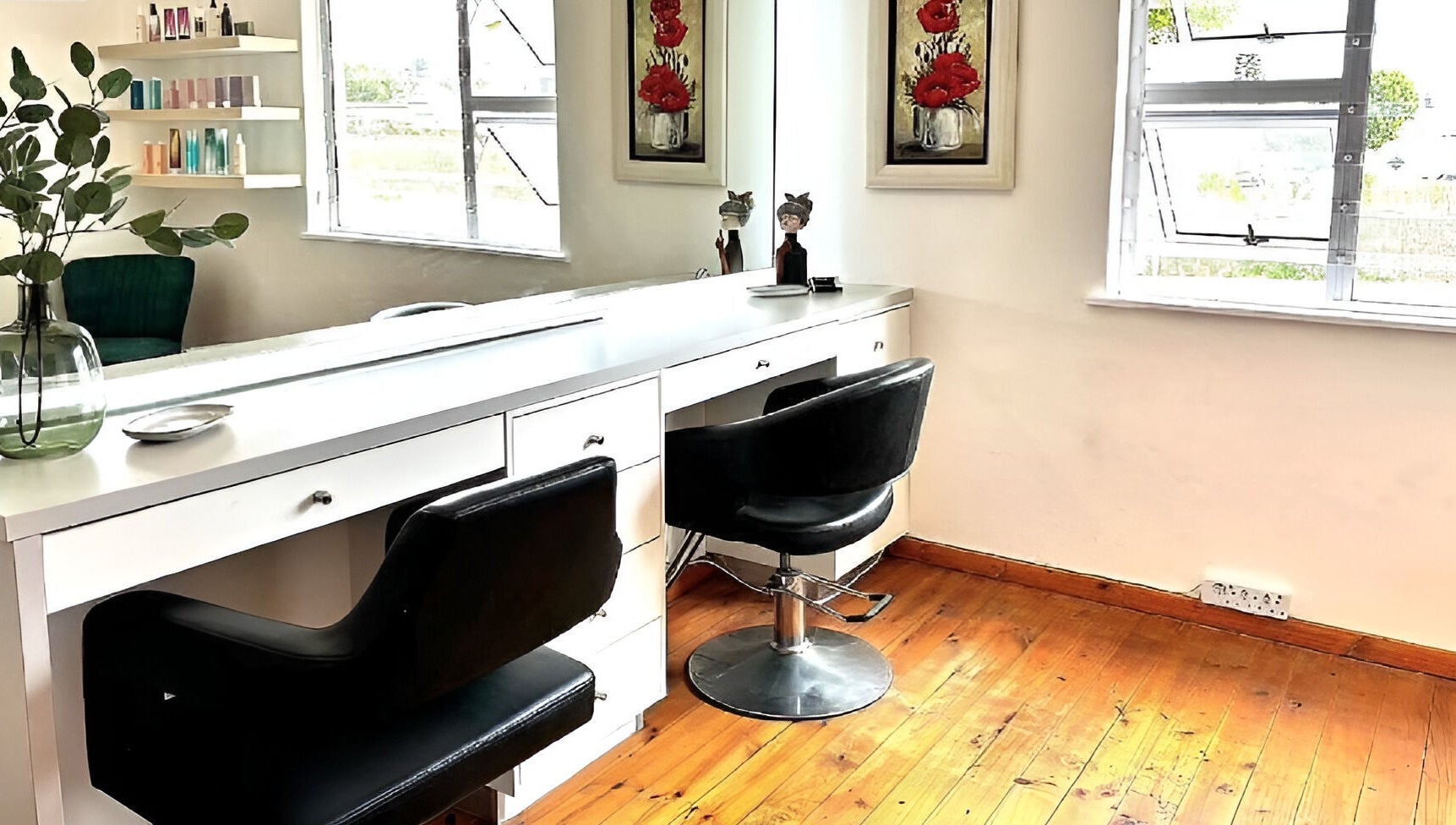Modern styling station at Rum and Ruby Hair Design, Hermanus, Western Cape, ZA with sleek chairs and decor.