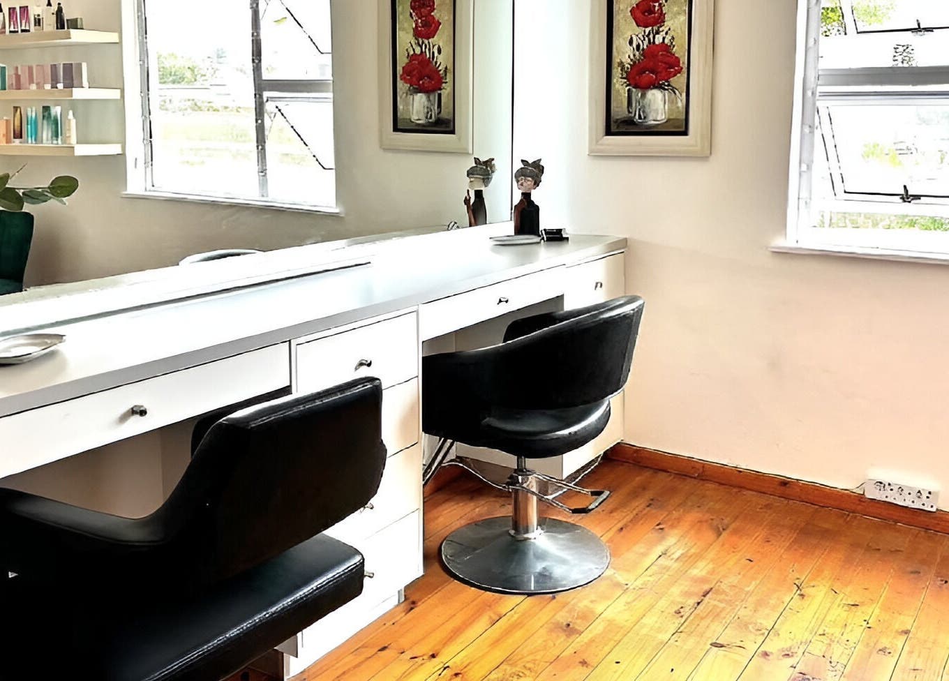 Modern styling station at Rum and Ruby Hair Design, Hermanus, Western Cape, ZA with sleek chairs and decor.