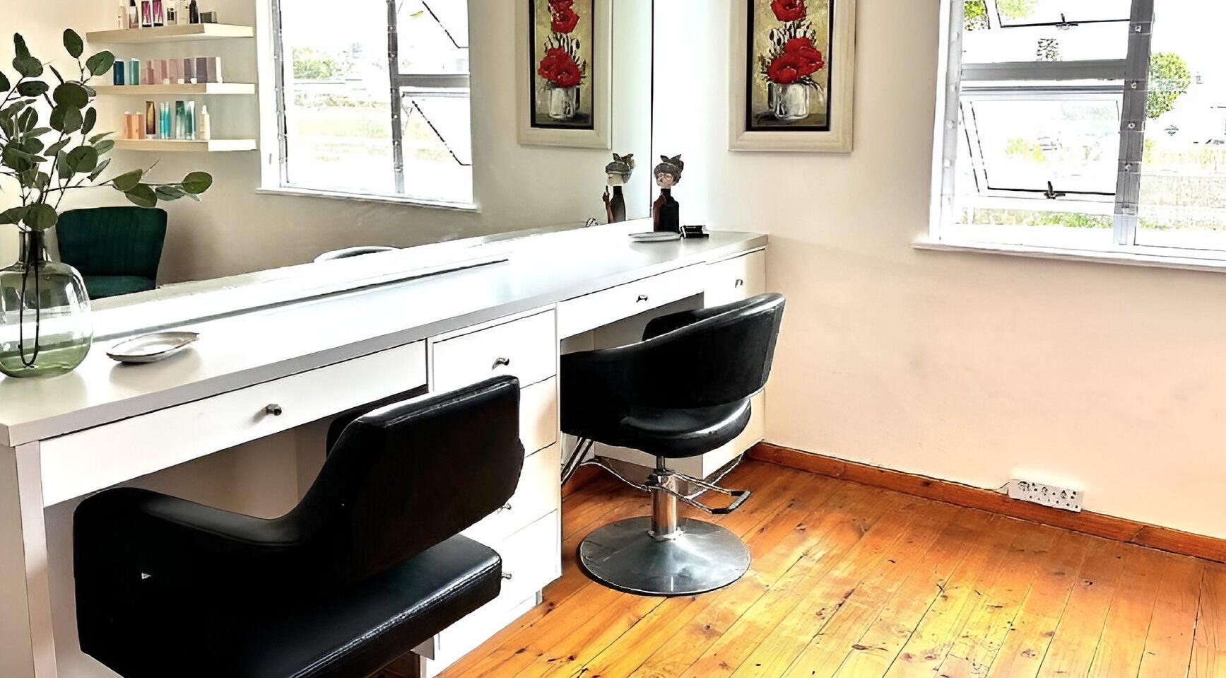 Modern styling station at Rum and Ruby Hair Design, Hermanus, Western Cape, ZA with sleek chairs and decor.