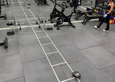 Spacious gym area at ELK - Novo, Brest, Bretagne, FR featuring exercise bikes and weights.