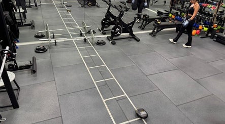 Spacious gym area at ELK - Novo, Brest, Bretagne, FR featuring exercise bikes and weights.
