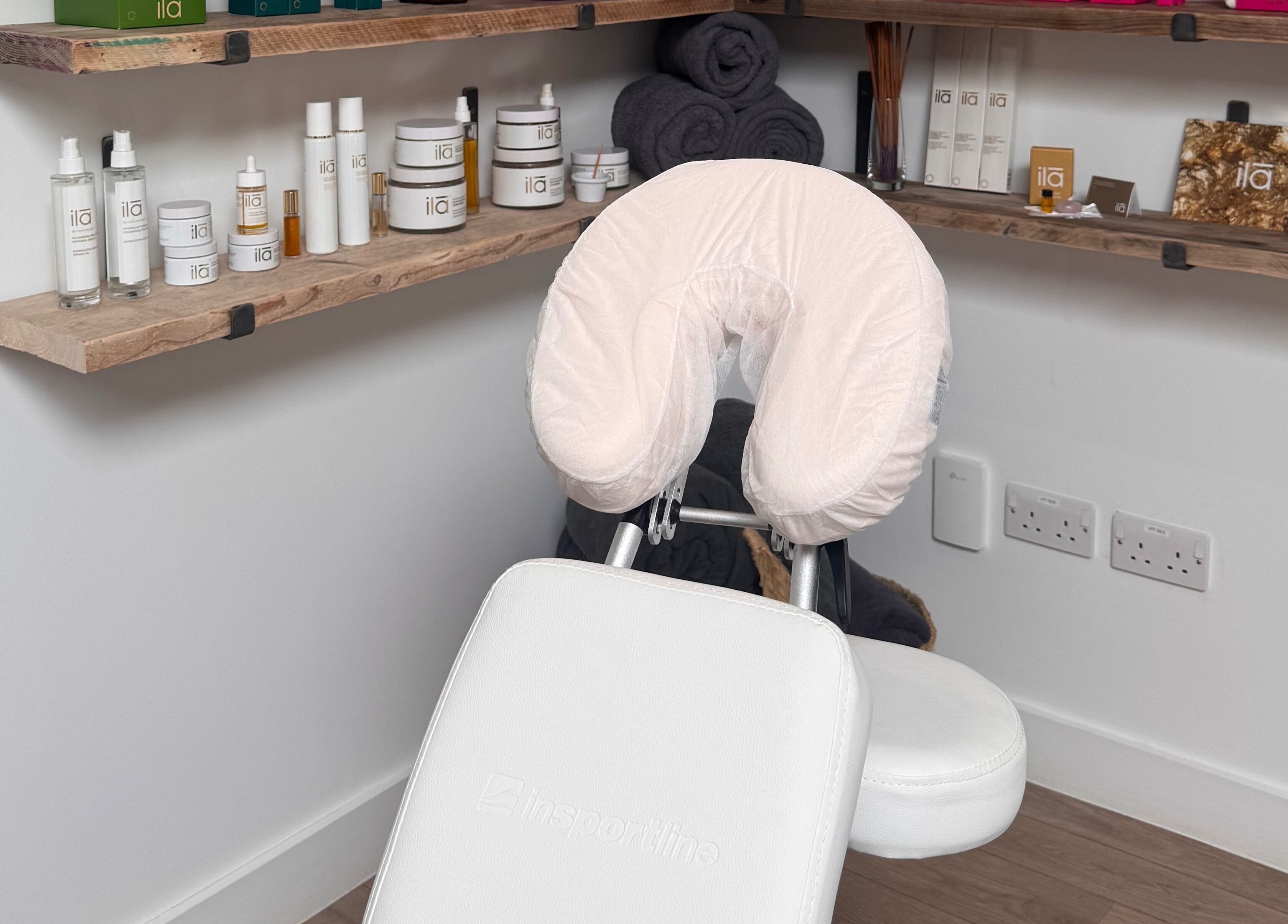 Massage chair at Spa Studio by Lost Shore, Newbridge, Scotland, GB, surrounded by beauty products.