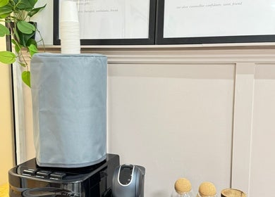 Refreshment station at BN Beauty - Rottingdean, Brighton And Hove, England, GB with a water cooler and greenery.