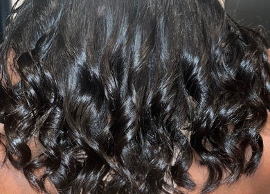 Luxurious dark curls styled at Blowout Boulevard, New York, New York, US.