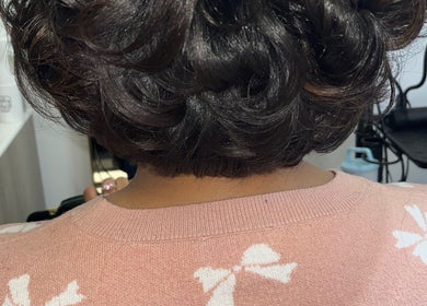 Stunning curled hairstyle at Blowout Boulevard, New York, New York, US, showcasing luxurious black hair.