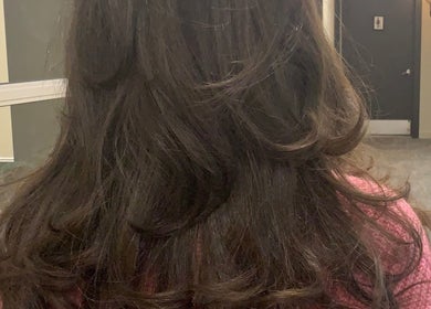 Elegant wavy brunette hairstyle at Blowout Boulevard, New York, New York, US, showcasing salon excellence.