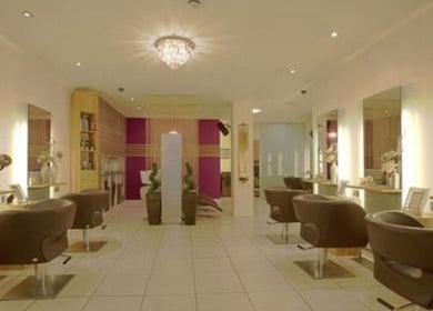 Chic salon interior at Adele@thetherapysuite, Inverness, Scotland, GB with stylish chairs and ambient lighting.