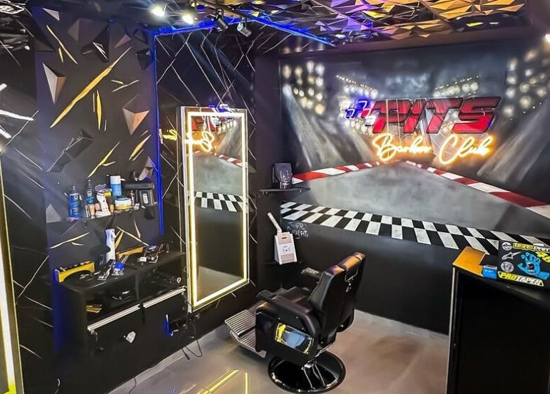 Trendy interior of Pits Barber Club in Buenos Aires, showcasing a modern salon setup with vibrant decor.