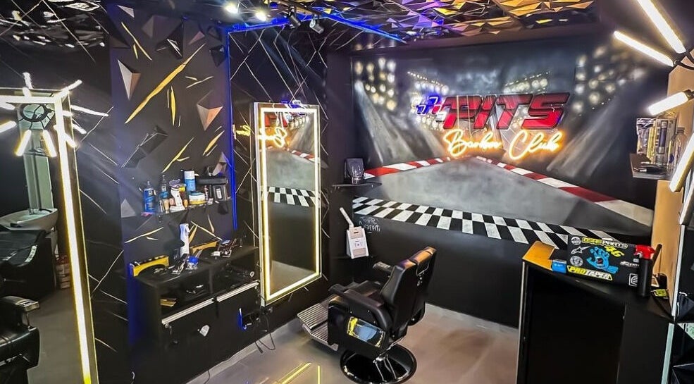 Trendy interior of Pits Barber Club in Buenos Aires, showcasing a modern salon setup with vibrant decor.
