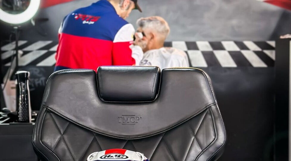 Barber chair at Pits Barber Club in Buenos Aires, Ciudad Autónoma De Buenos Aires, AR with stylist in background.