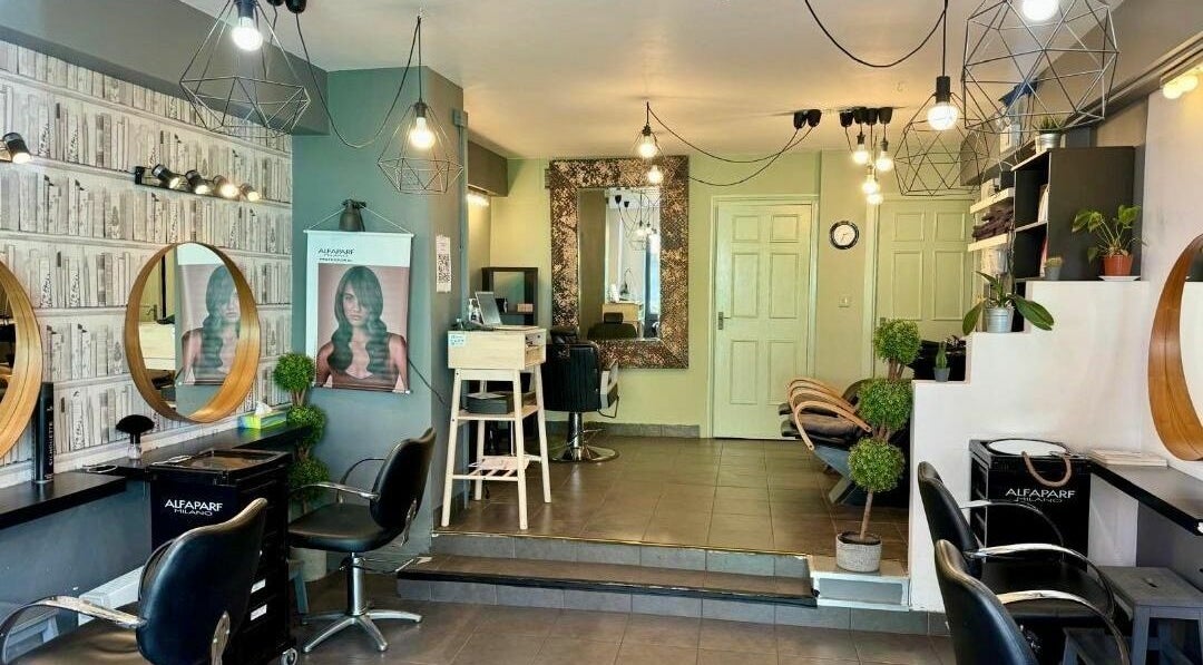 Chic salon interior at The V Studio Limited, Dublin, County Dublin, IE with modern mirrors and stylish chairs.