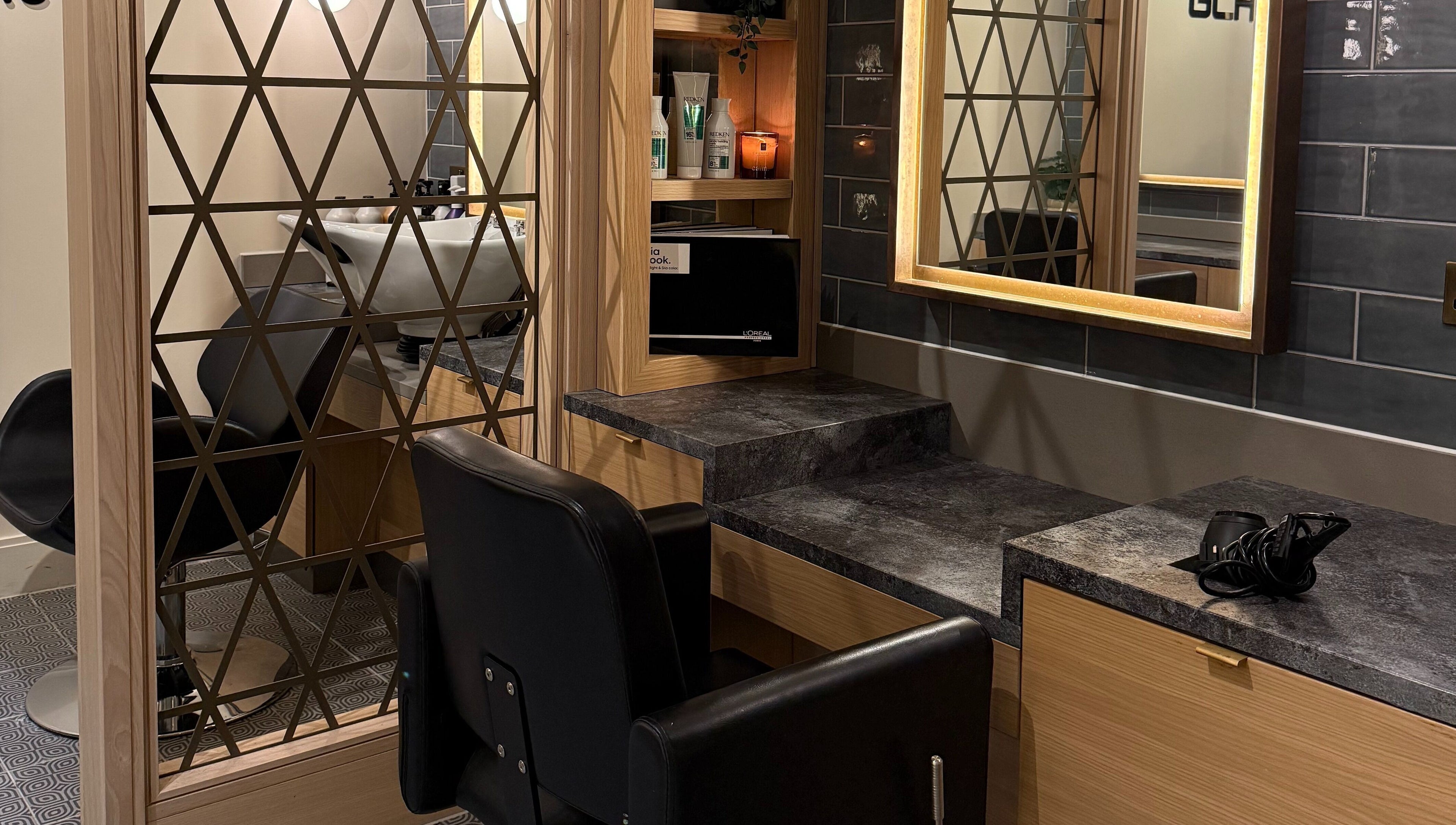 Stylish salon interior at GLAZED By JC in Mottram, England with modern mirrors and sleek styling stations.