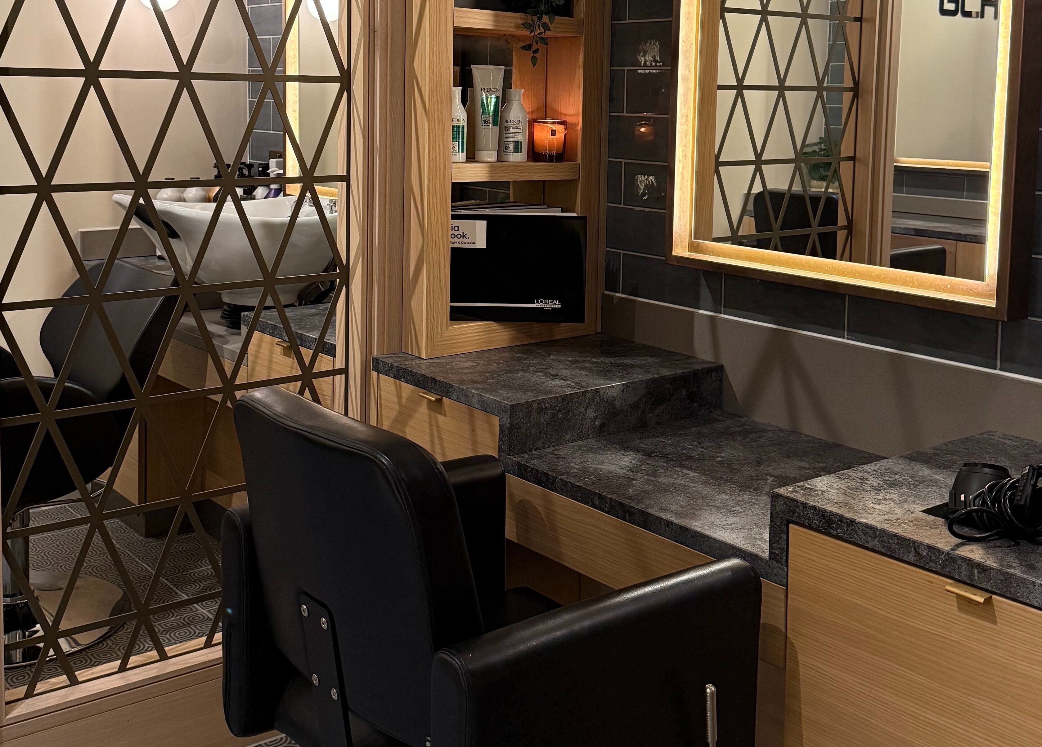 Stylish salon interior at GLAZED By JC in Mottram, England with modern mirrors and sleek styling stations.