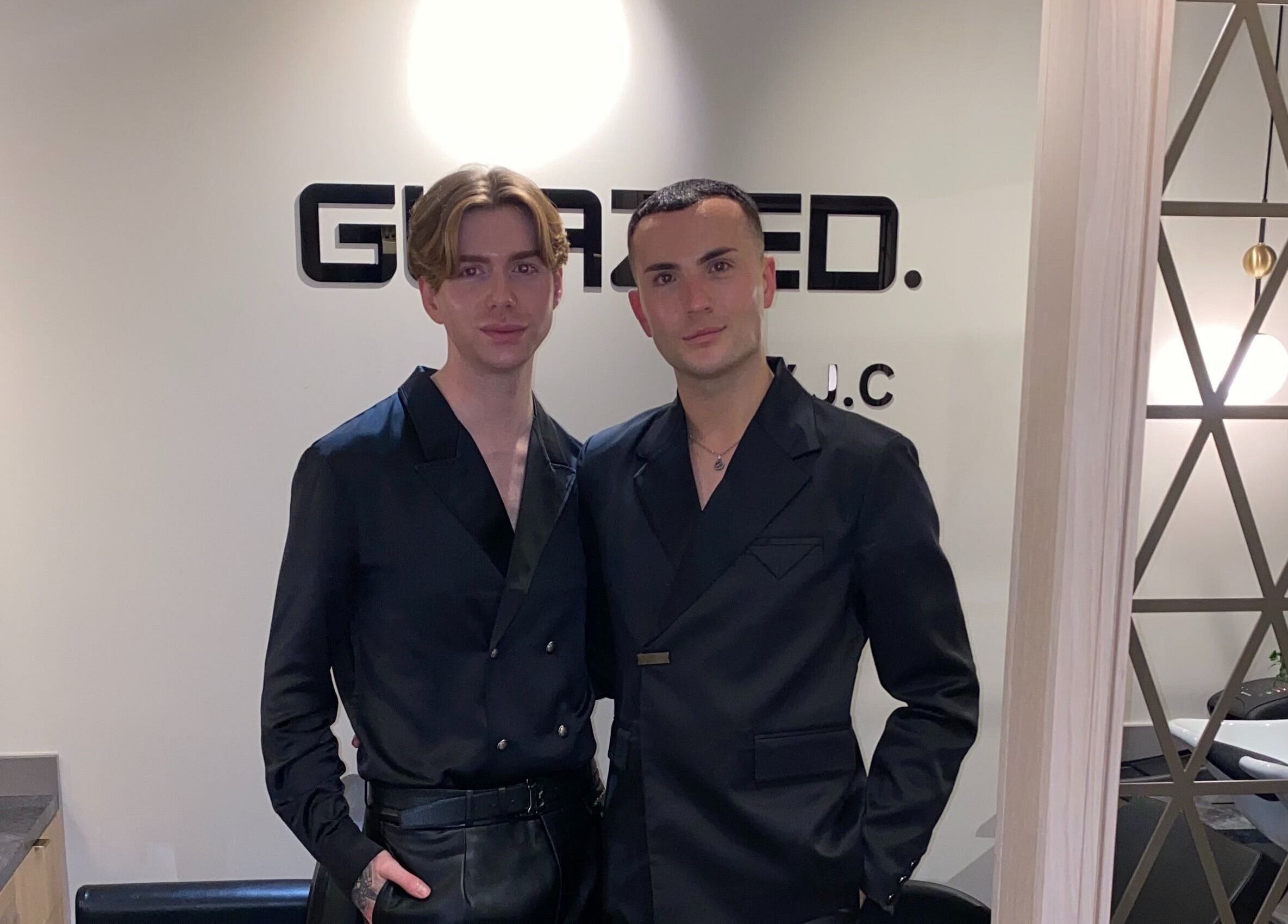 Two individuals at GLAZED By JC salon, Mottram, England, GB, showcasing elegant attire.