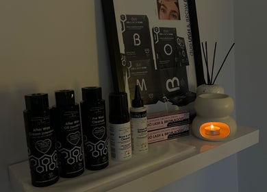 Wax and skincare products on shelf at The Hideaway By Carly in Manchester, England, GB with soft candlelight.