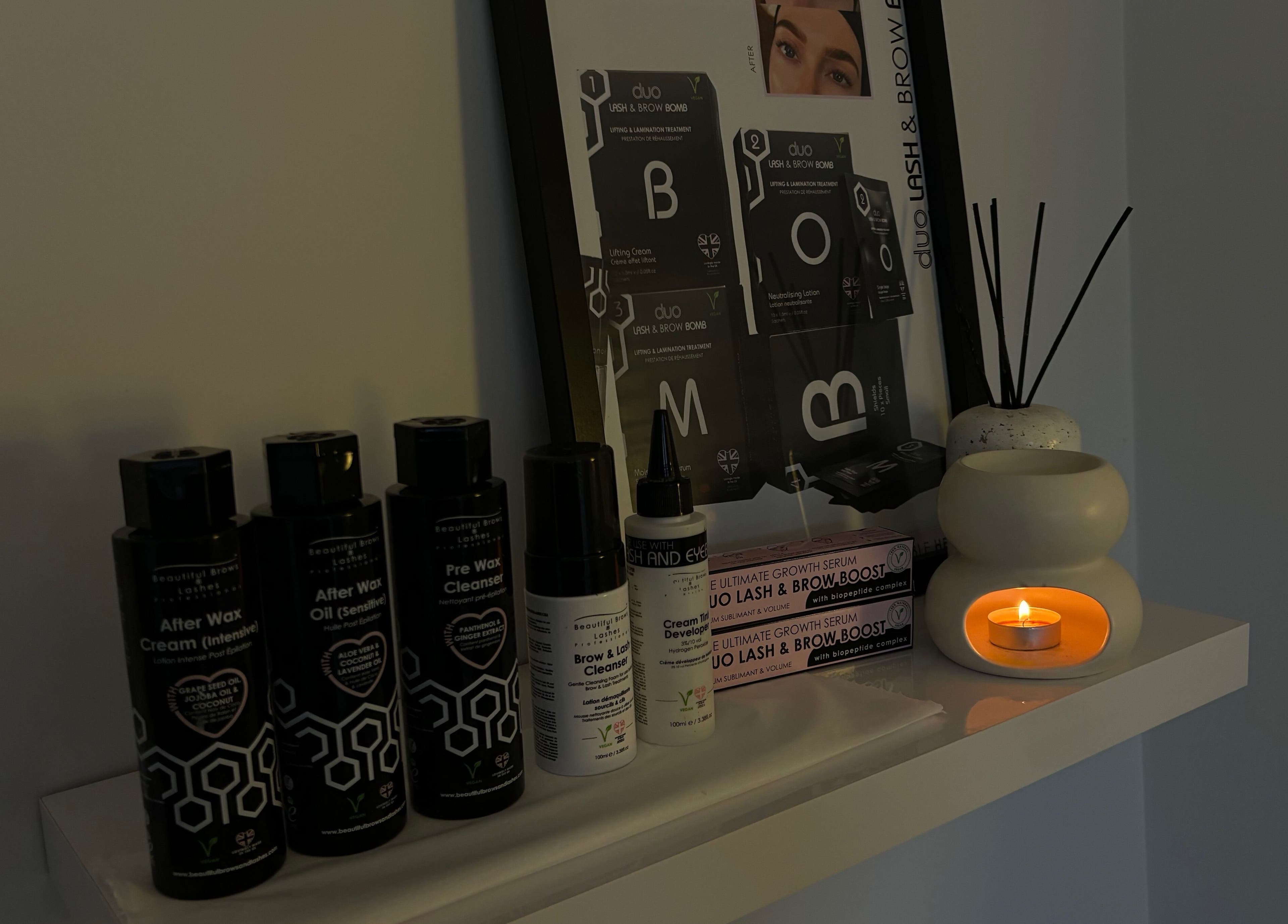 Wax and skincare products on shelf at The Hideaway By Carly in Manchester, England, GB with soft candlelight.