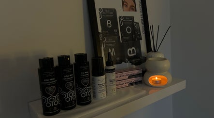 Wax and skincare products on shelf at The Hideaway By Carly in Manchester, England, GB with soft candlelight.