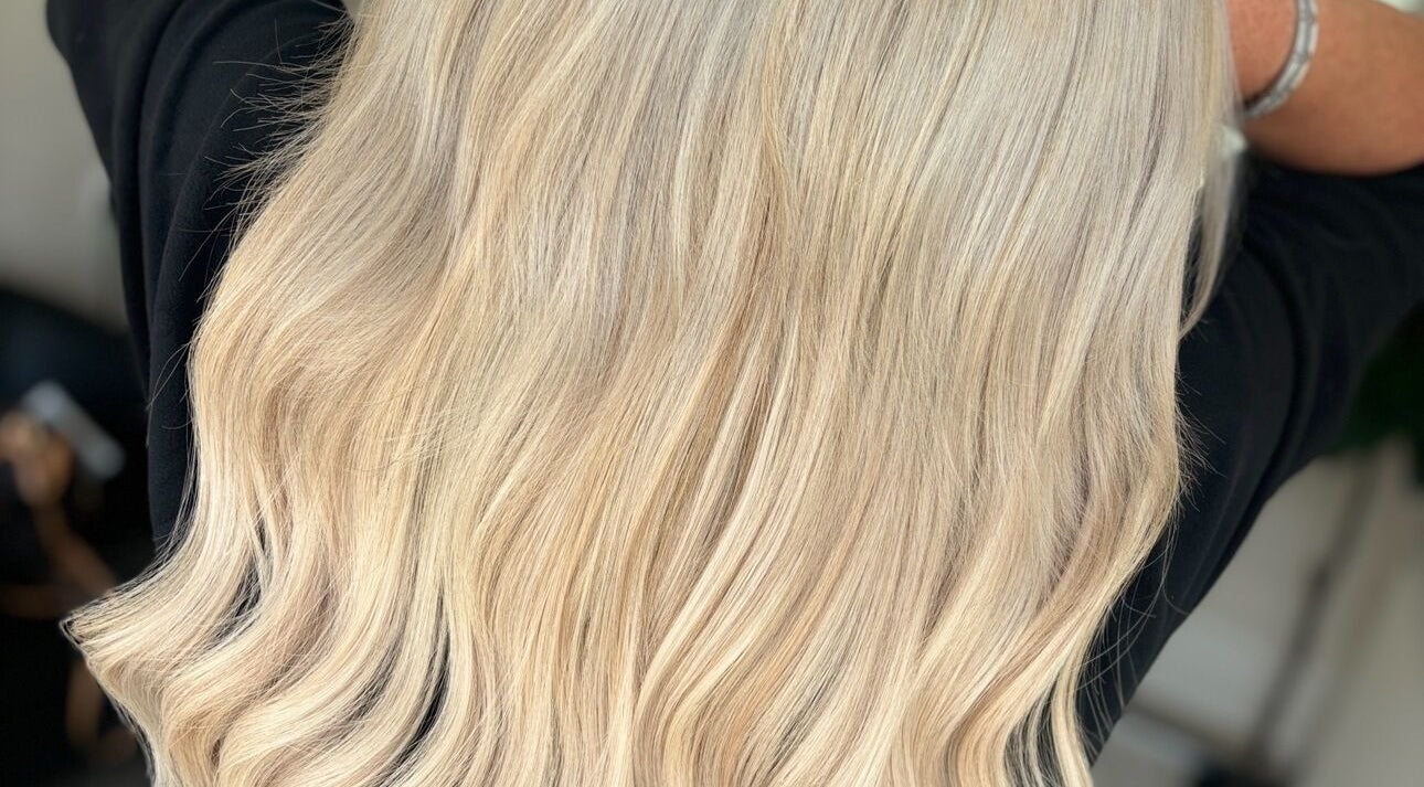 Flowing blonde hair styled at HairbyKeiraMae in Southampton, England, GB showcasing expert coloring.