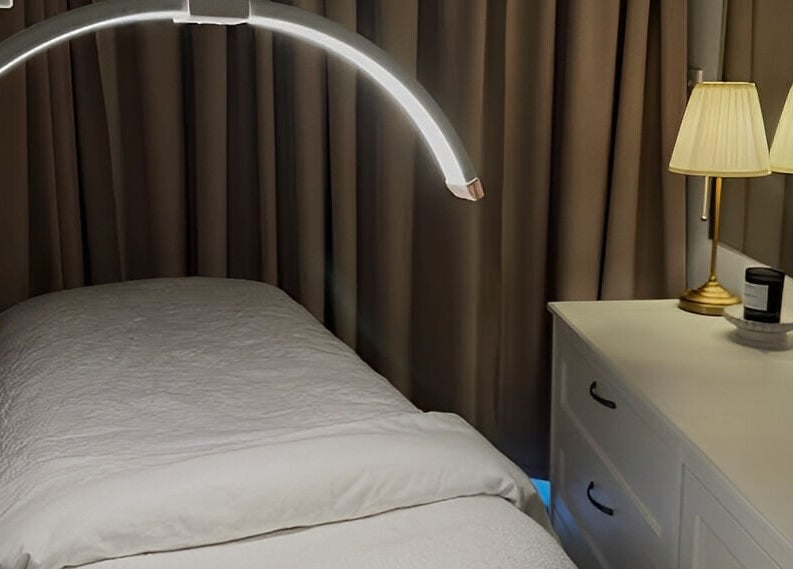 Cozy treatment room at JK Skin Studio, Double Bay, New South Wales, AU with soft lighting and white linens.