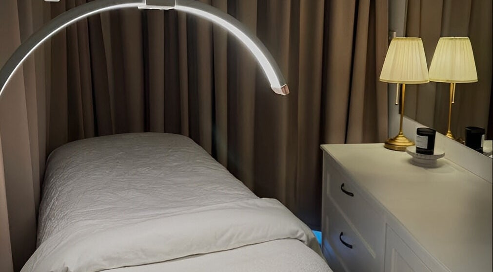 Cozy treatment room at JK Skin Studio, Double Bay, New South Wales, AU with soft lighting and white linens.