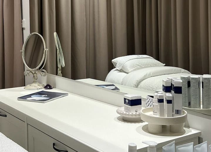 Elegant treatment room at JK Skin Studio, Double Bay, New South Wales, AU with skincare products on display.