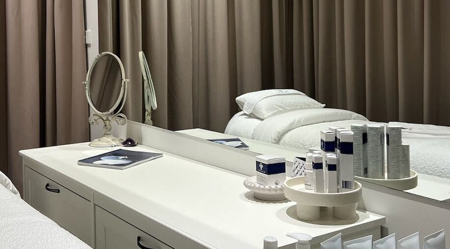Elegant treatment room at JK Skin Studio, Double Bay, New South Wales, AU with skincare products on display.