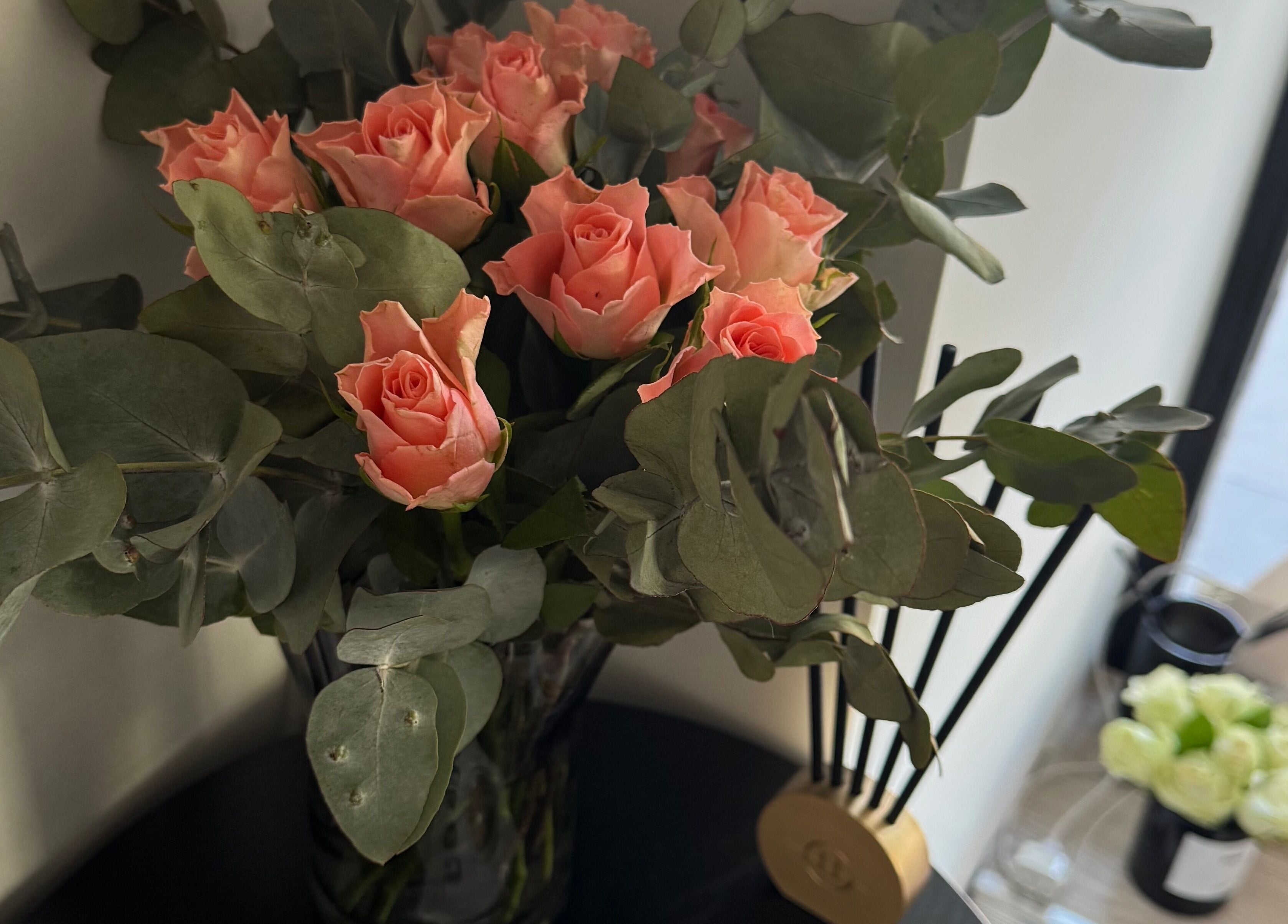 Pink roses in vase at JK Skin Studio, Double Bay, New South Wales, AU, offering serene ambience.