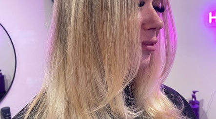Stylish blonde hairstyle at HOUSE OF BLONDE, Drouin, Victoria, AU with glowing salon ambiance.