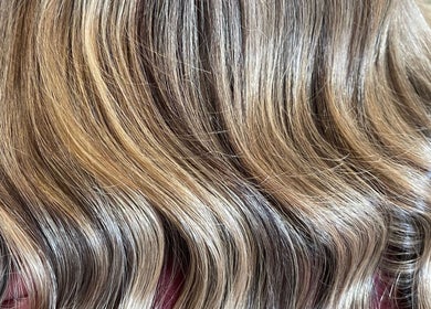 Elegant blonde waves styled at HOUSE OF BLONDE in Drouin, Victoria, AU, showcasing color and texture.