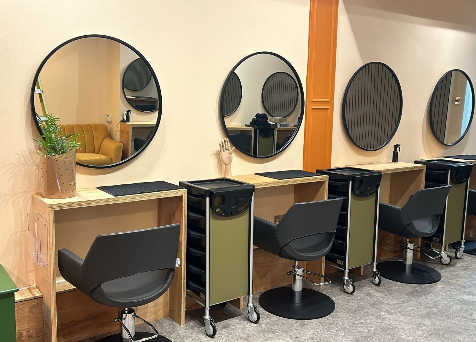 Elegant salon styling stations at Peach 37, Exeter, England, GB, featuring chic mirrors and modern chairs.