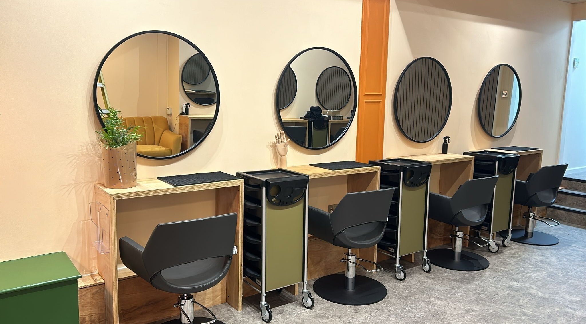 Elegant salon styling stations at Peach 37, Exeter, England, GB, featuring chic mirrors and modern chairs.