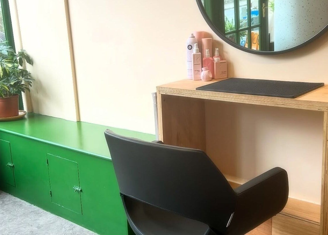 Modern beauty station setup at Peach 37 in Exeter, England, GB with a mirror, chair, and greenery decor.