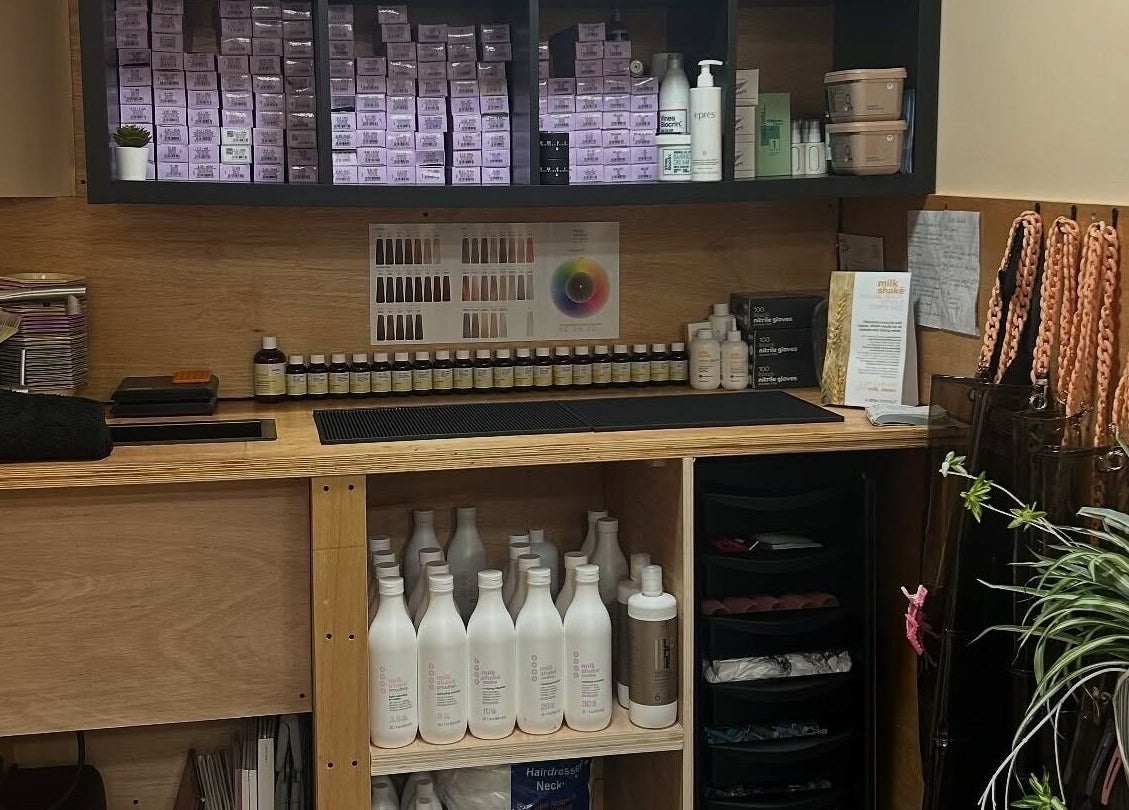 Professional salon shelving at Peach 37 in Exeter, England, GB showcasing beauty products and a modern, organized space.