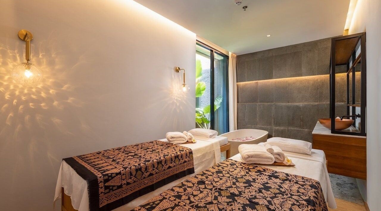Relaxing massage room at Ame Spa Kuningan in Daerah Khusus Ibukota Jakarta, ID with two tables and soft lighting.