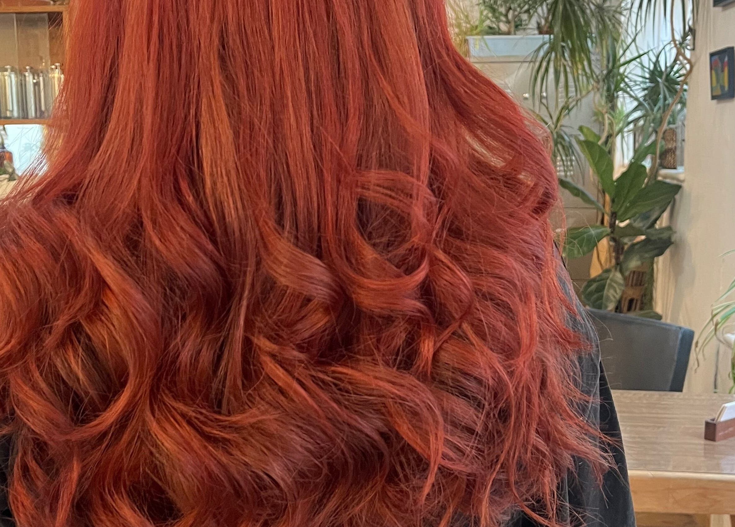 Vibrant red curls styled at Sara @ The Loft by Westworks Collective, Bexhill, England, GB. Lush salon ambiance.