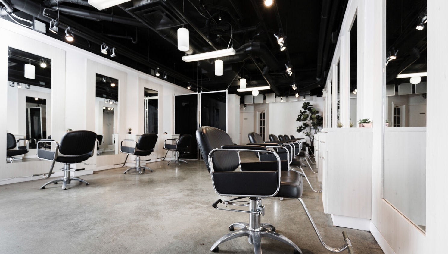 Interior of Sejong Hair Salon Kerrisdale in Vancouver, British Columbia, CA with modern styling chairs and mirrors.