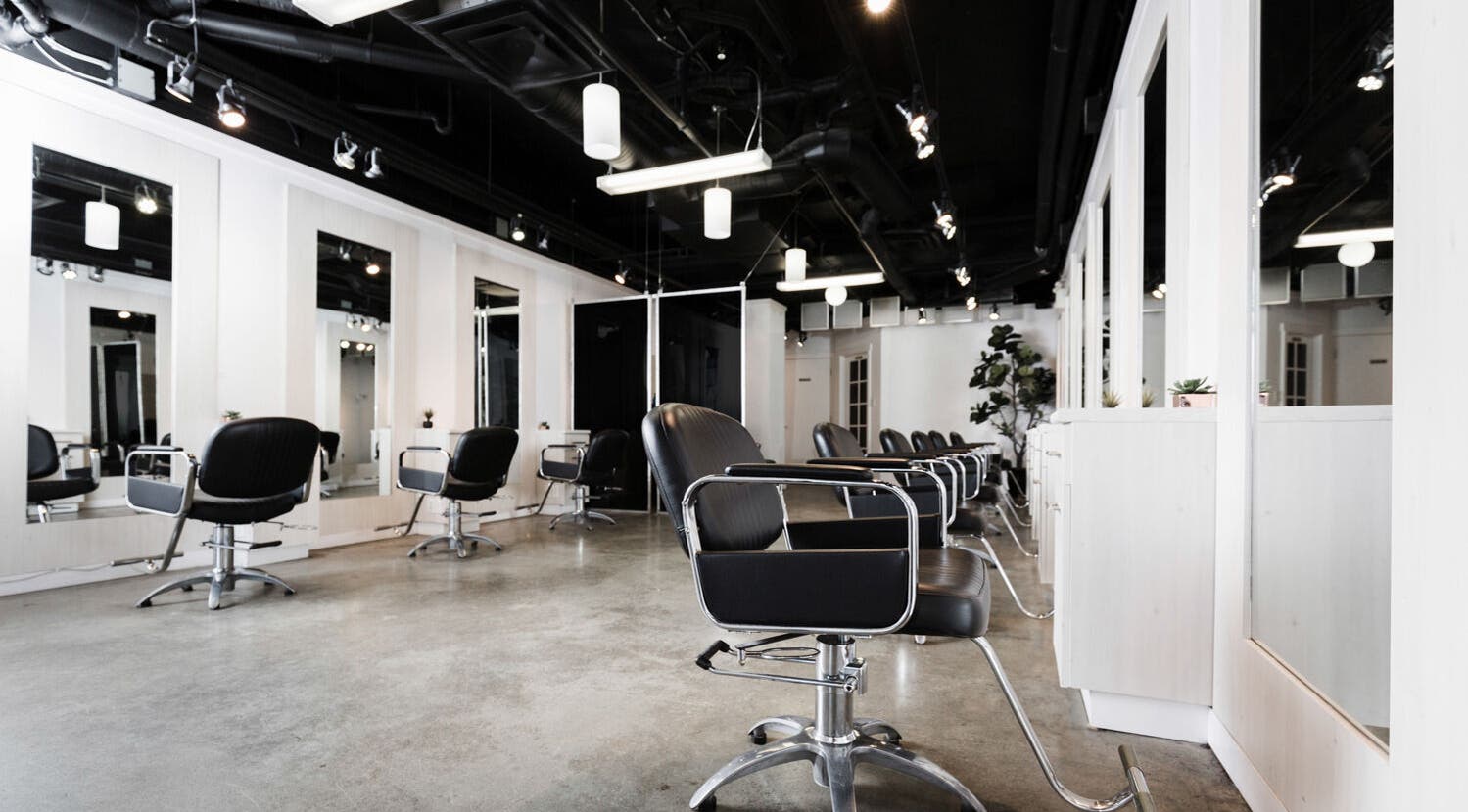 Interior of Sejong Hair Salon Kerrisdale in Vancouver, British Columbia, CA with modern styling chairs and mirrors.