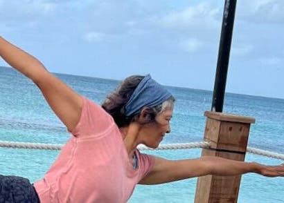 Person practicing yoga by the sea at Breathe with Betty, Grand Cayman, KY, enhancing wellness and serenity.